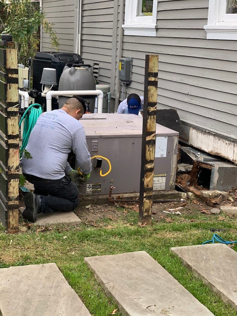An Agility technician diagnosing an outdoor AC unit